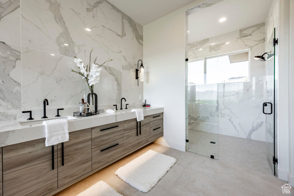 Bathroom featuring vanity and a shower with shower door