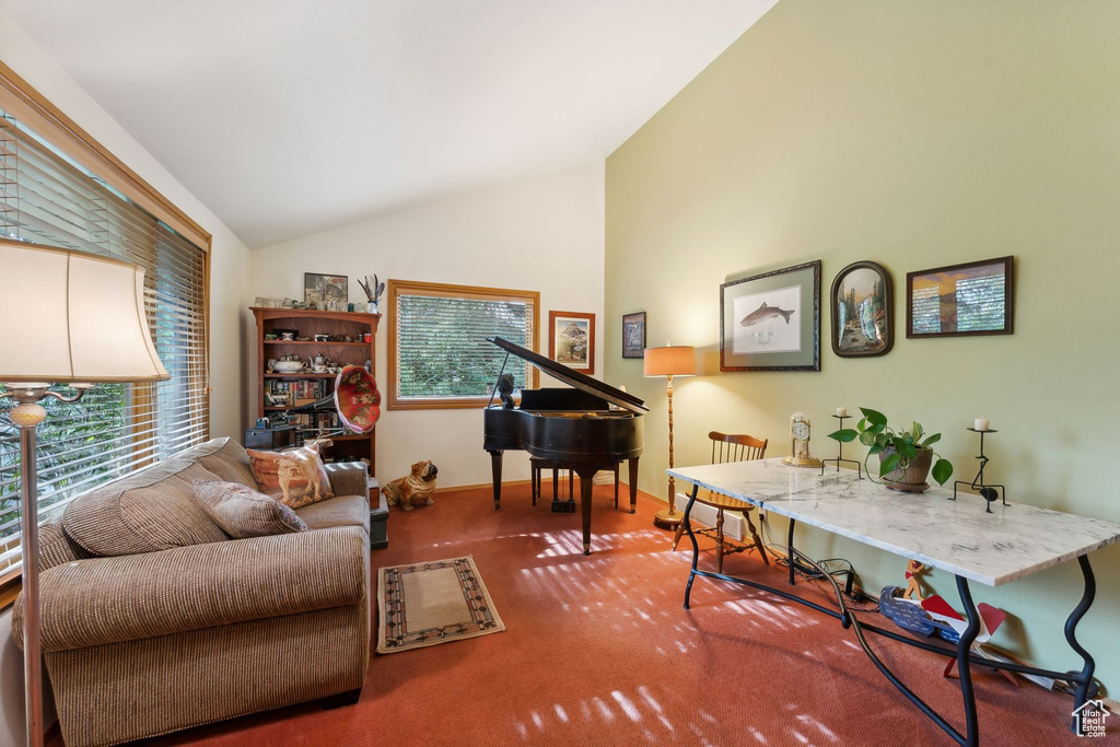 Living room featuring high vaulted ceiling