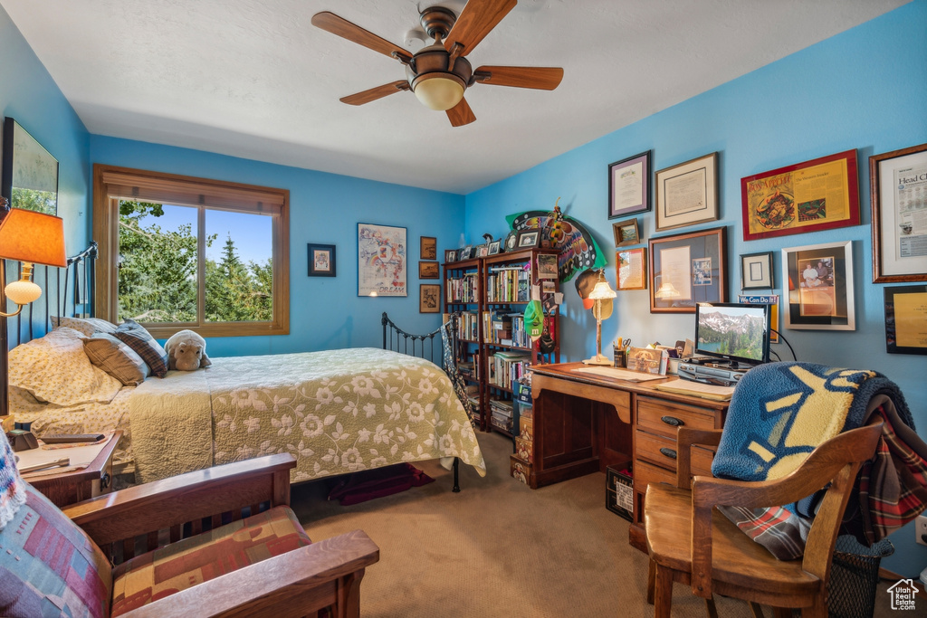 Bedroom featuring ceiling fan and carpet floors