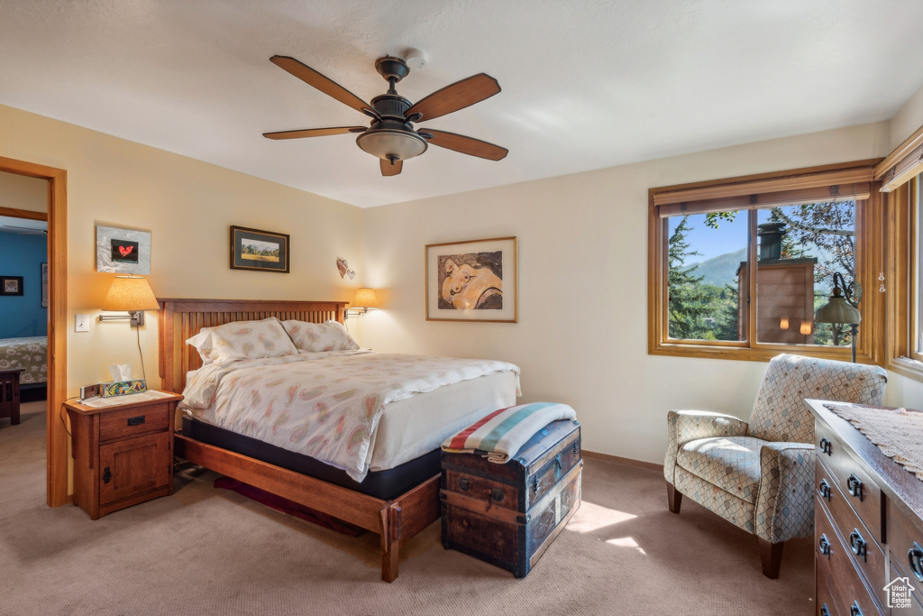 Bedroom with ceiling fan and carpet flooring