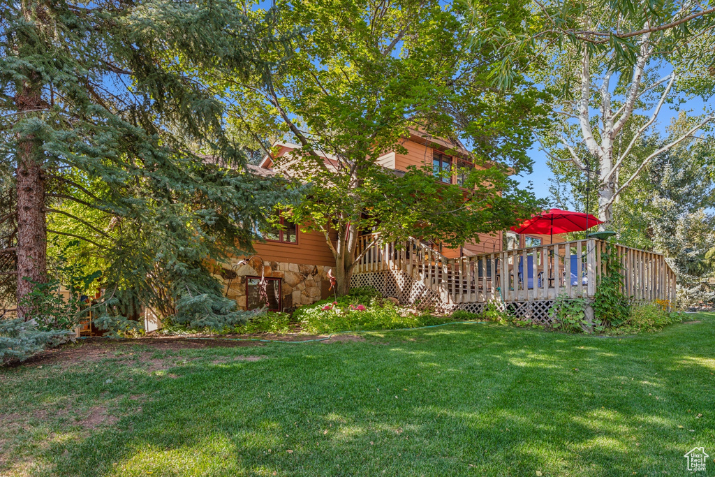 View of yard with a wooden deck