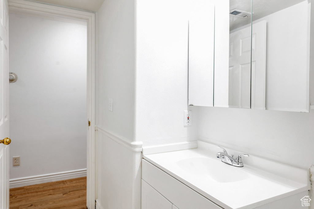 Bathroom featuring vanity and hardwood / wood-style flooring