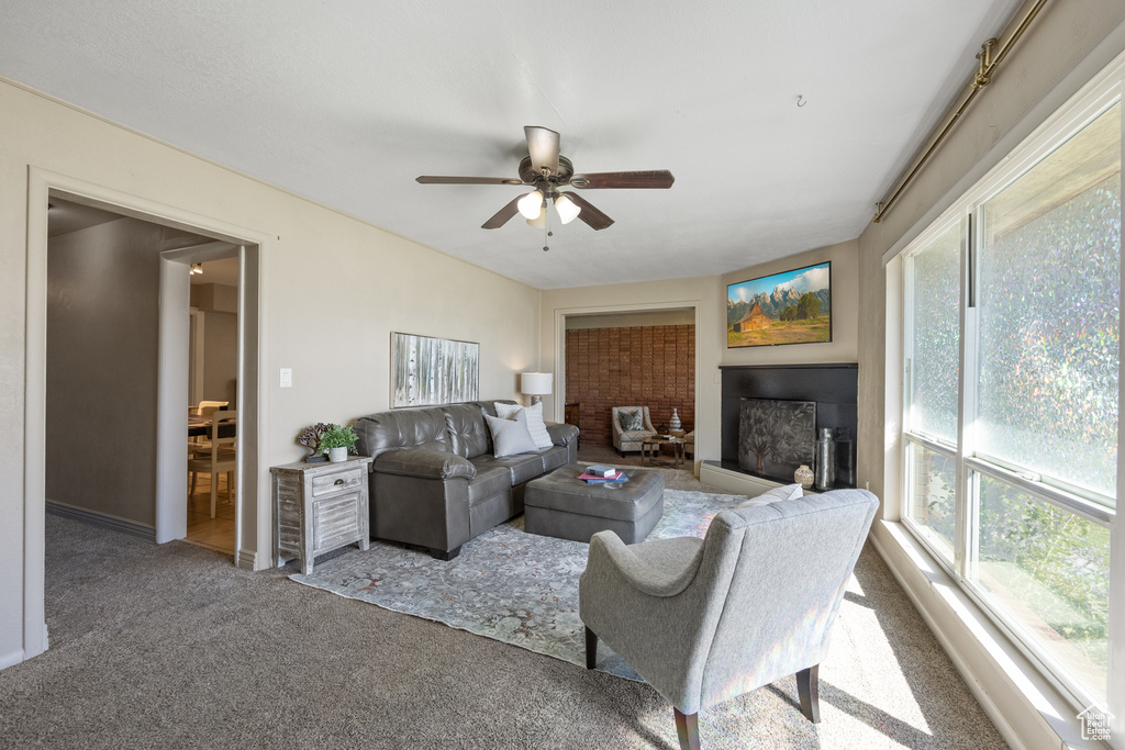 Living room featuring ceiling fan and carpet floors