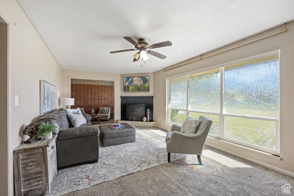 Living room featuring carpet flooring and ceiling fan