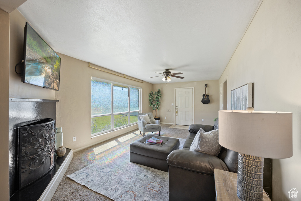 Living room with ceiling fan and carpet floors