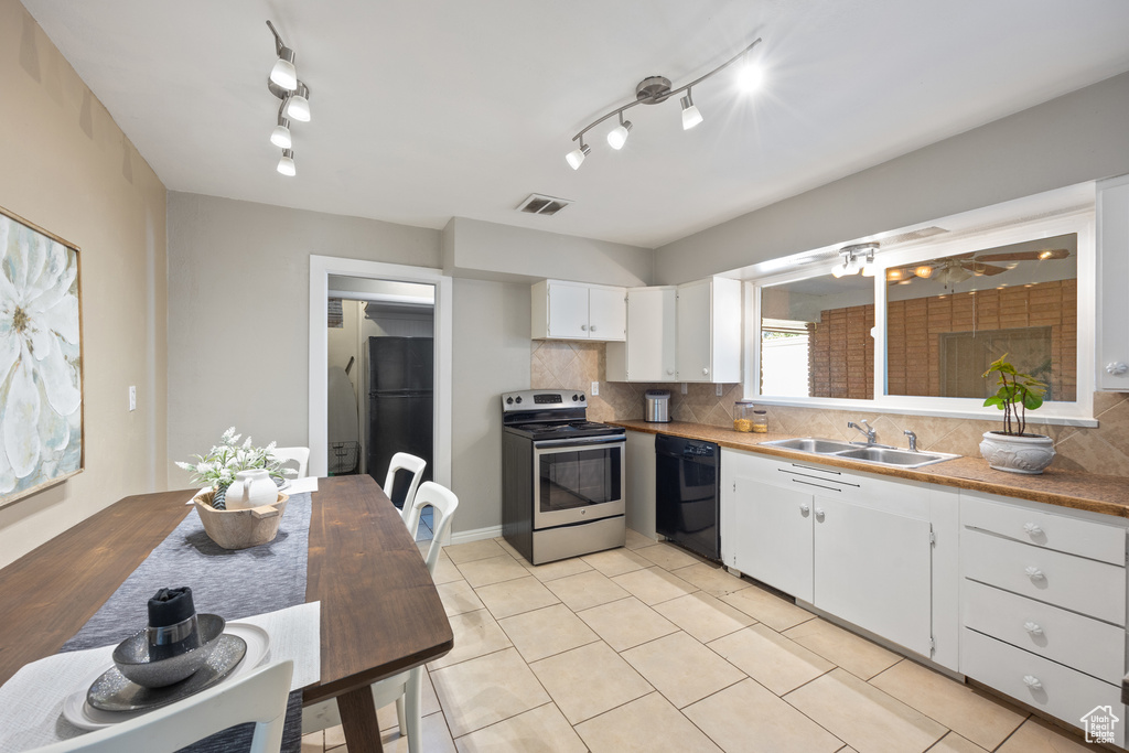 Kitchen with sink, white cabinetry, rail lighting, decorative backsplash, and black appliances