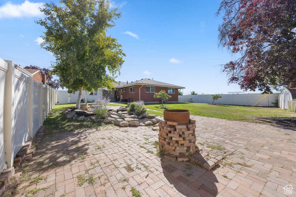 View of patio with a shed