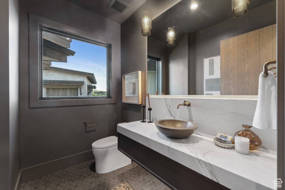 Bathroom with tile patterned floors, vanity, and toilet