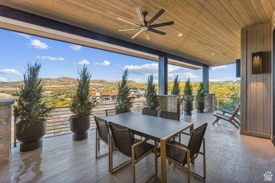 View of patio / terrace featuring ceiling fan and a mountain view