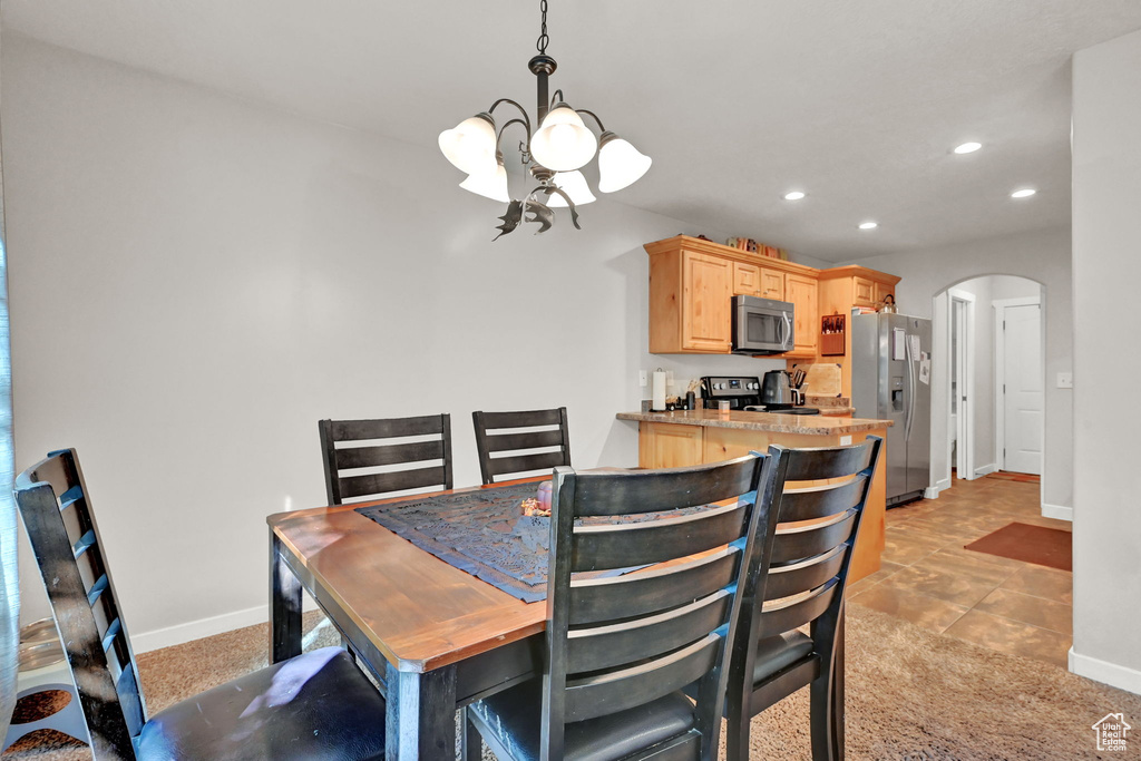 Tiled dining space with a notable chandelier