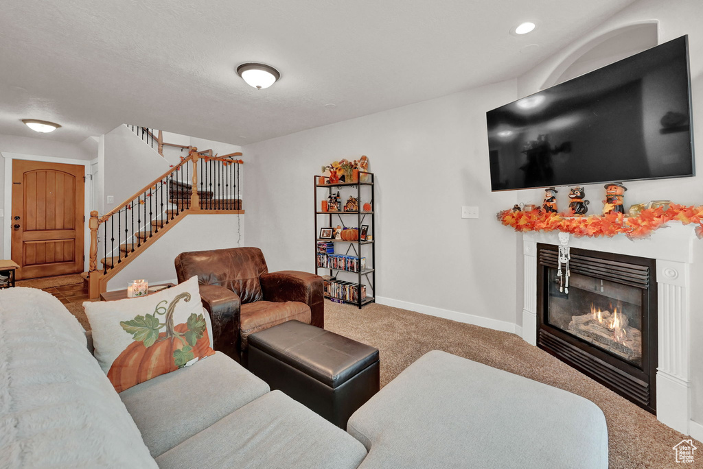 Living room featuring a tile fireplace and carpet flooring