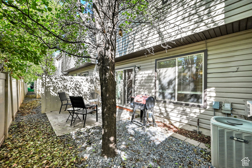 View of patio featuring a grill and central air condition unit