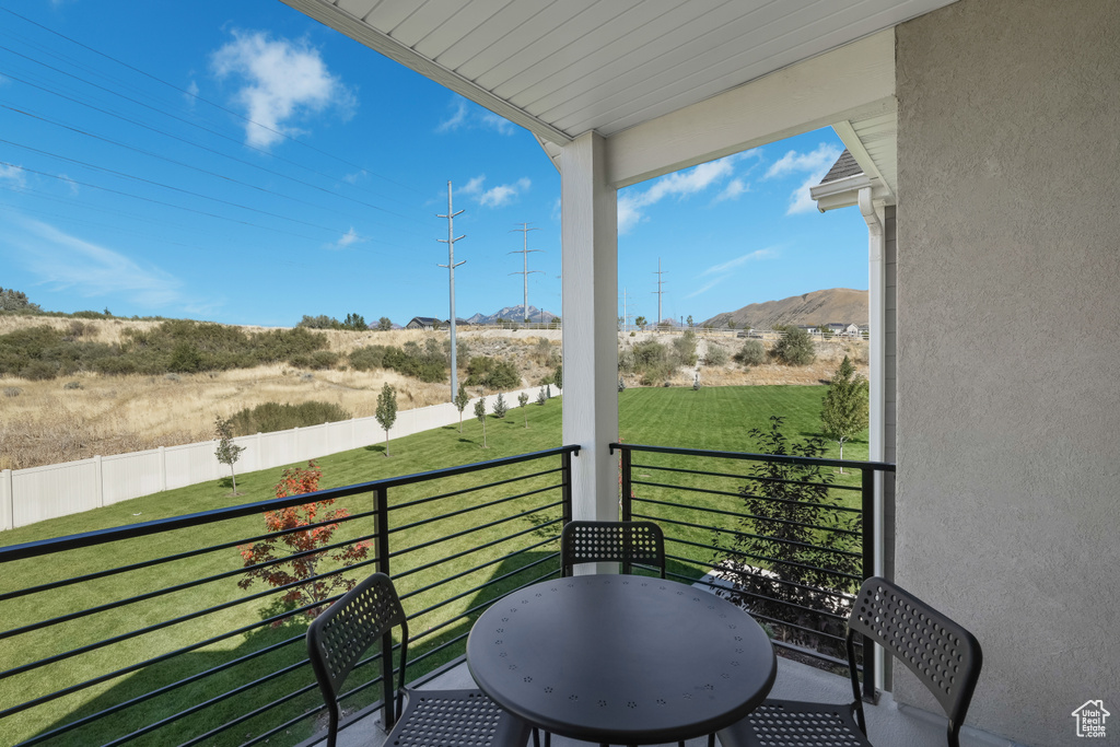 Balcony featuring a mountain view and a rural view