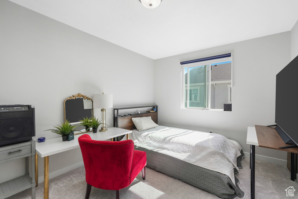 Bedroom featuring light carpet