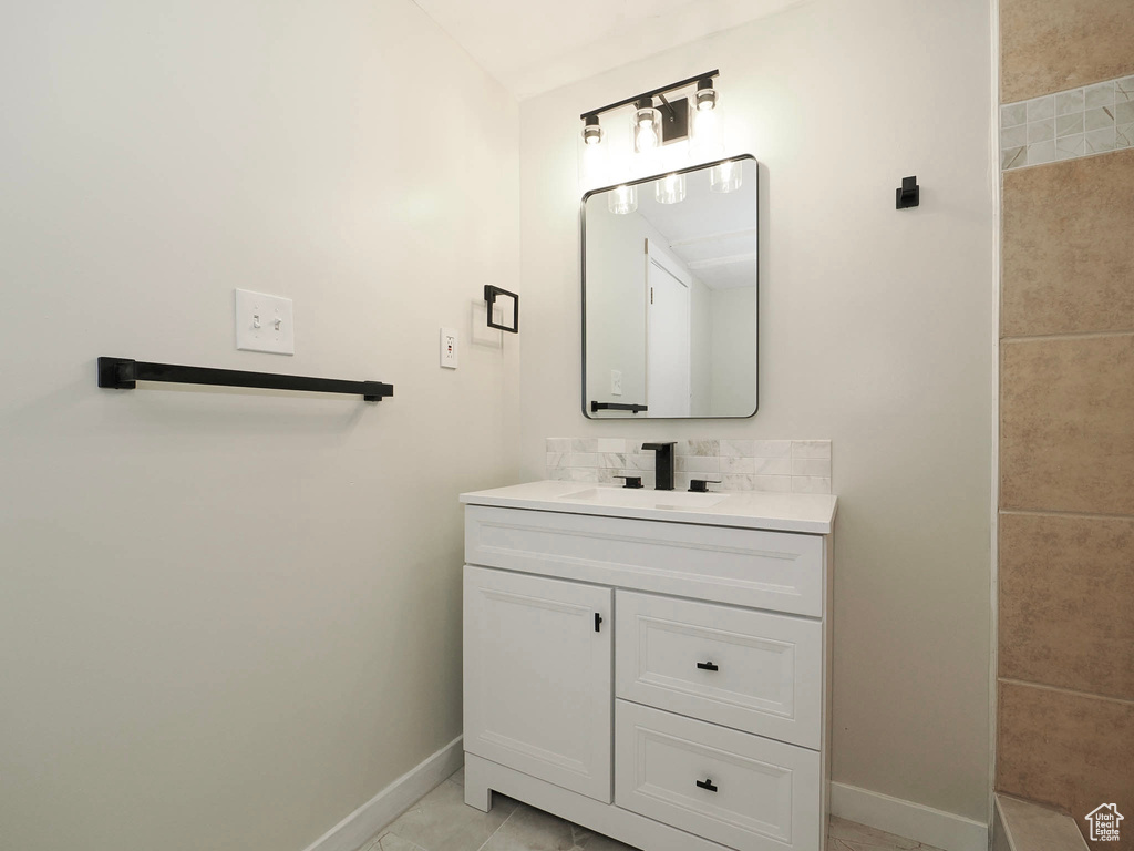 Bathroom with tile patterned flooring and vanity