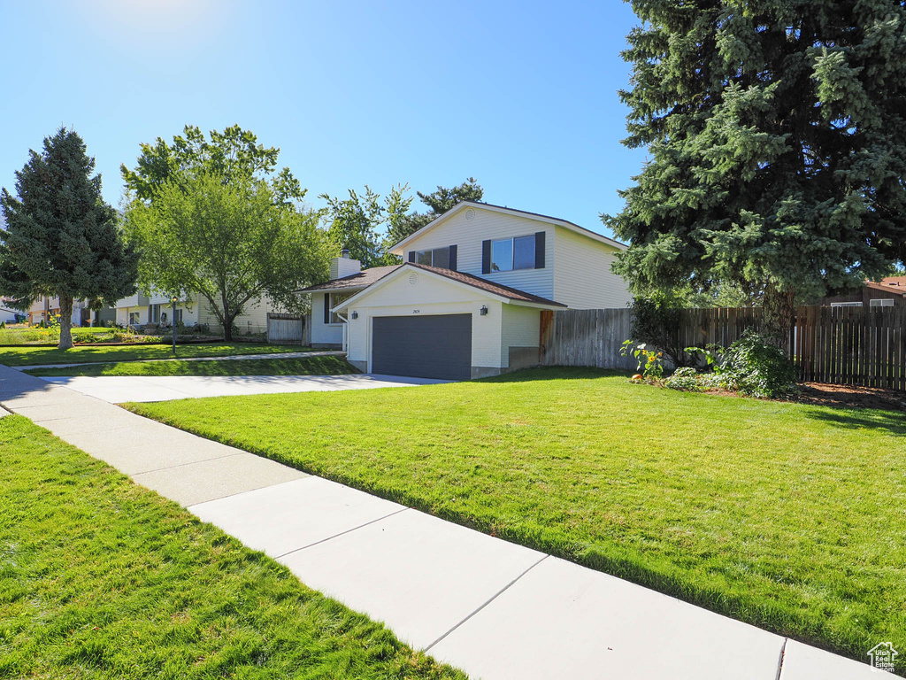 View of front facade with a garage and a front yard