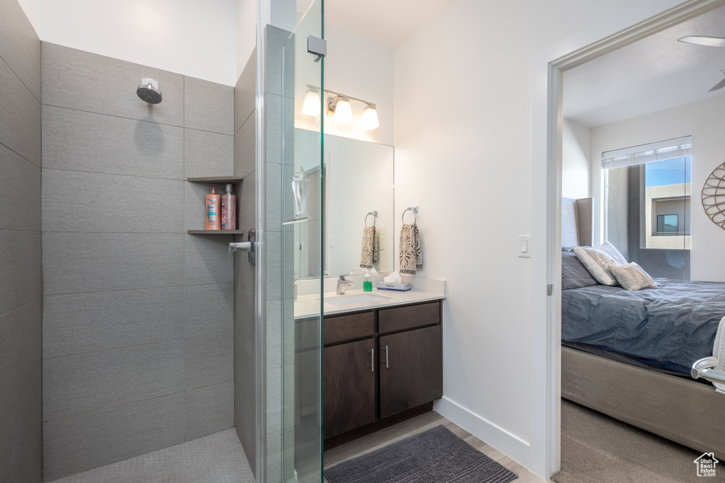 Bathroom with vanity and tiled shower