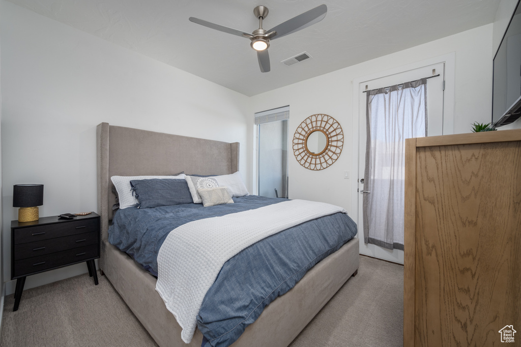 Bedroom with ceiling fan and light colored carpet