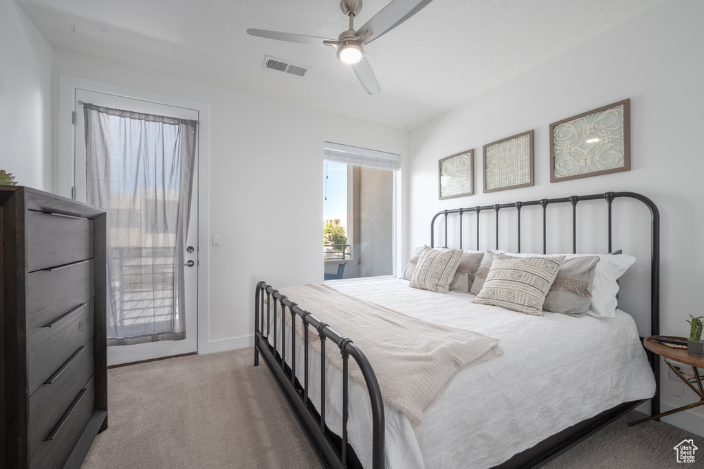 Bedroom featuring access to outside, carpet flooring, and ceiling fan