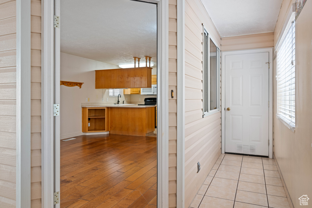 Interior space with sink and light hardwood / wood-style flooring