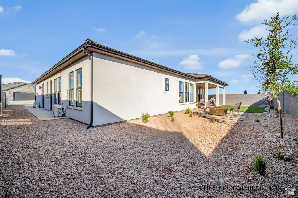 View of property exterior with a patio and central AC unit