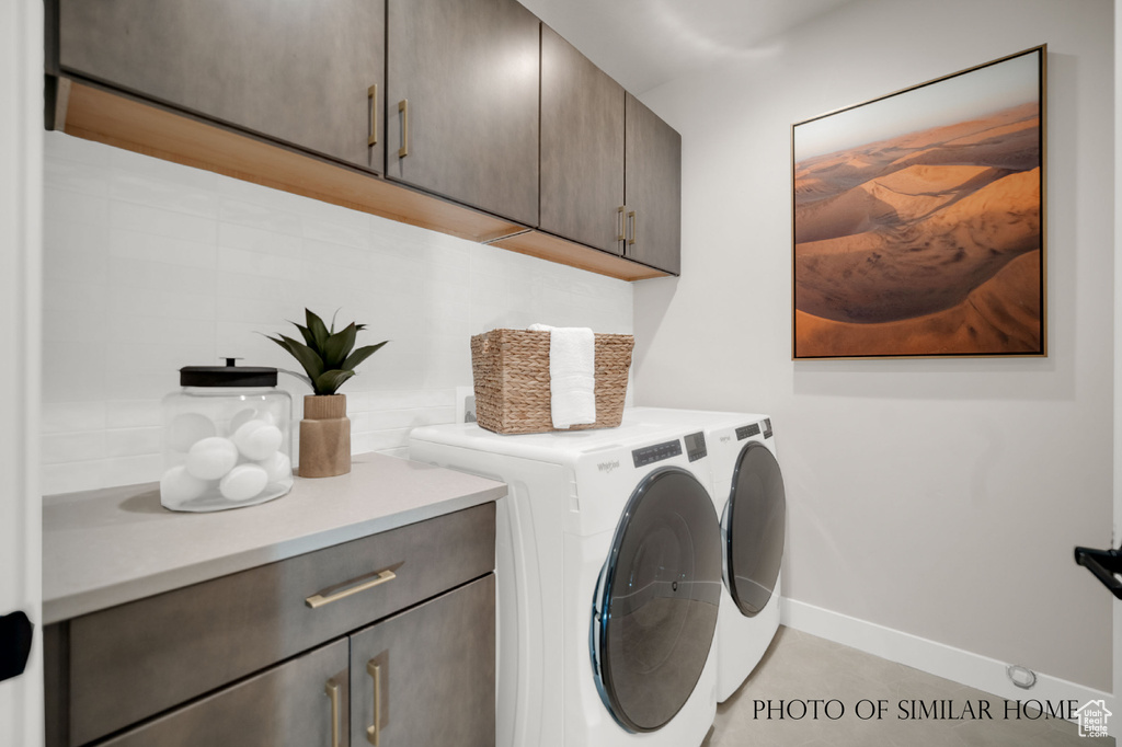 Laundry room with independent washer and dryer and cabinets