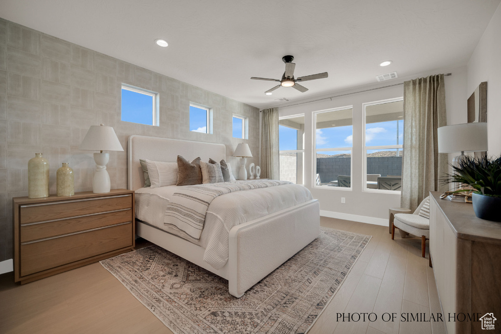 Bedroom featuring ceiling fan and hardwood / wood-style floors