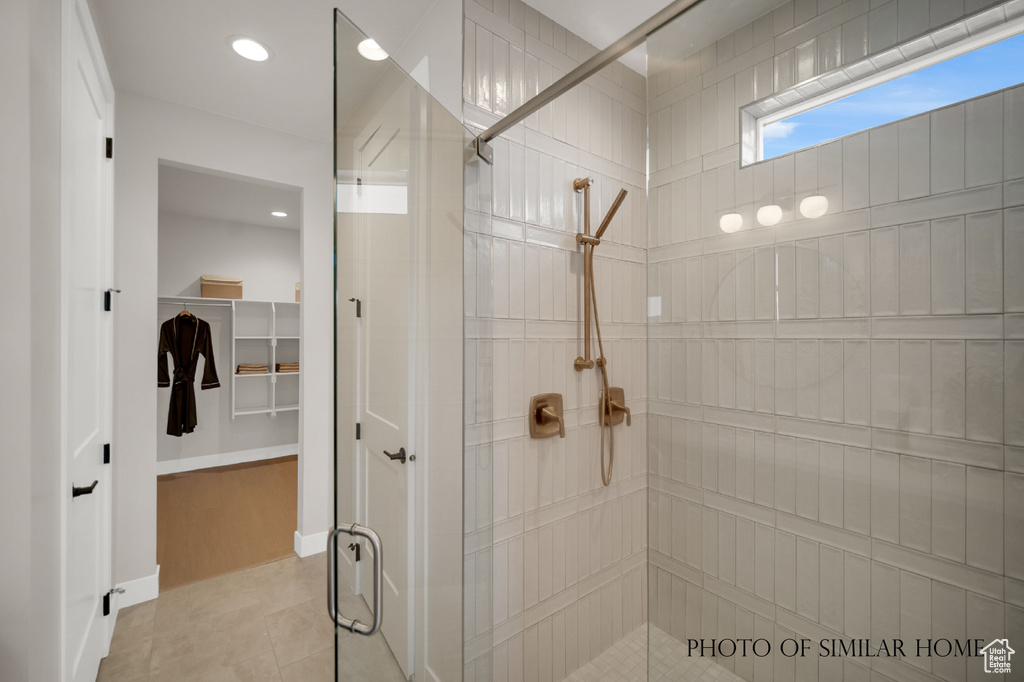 Bathroom with wood-type flooring and a shower with door