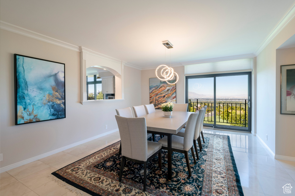 Tiled dining room featuring ornamental molding and a wealth of natural light