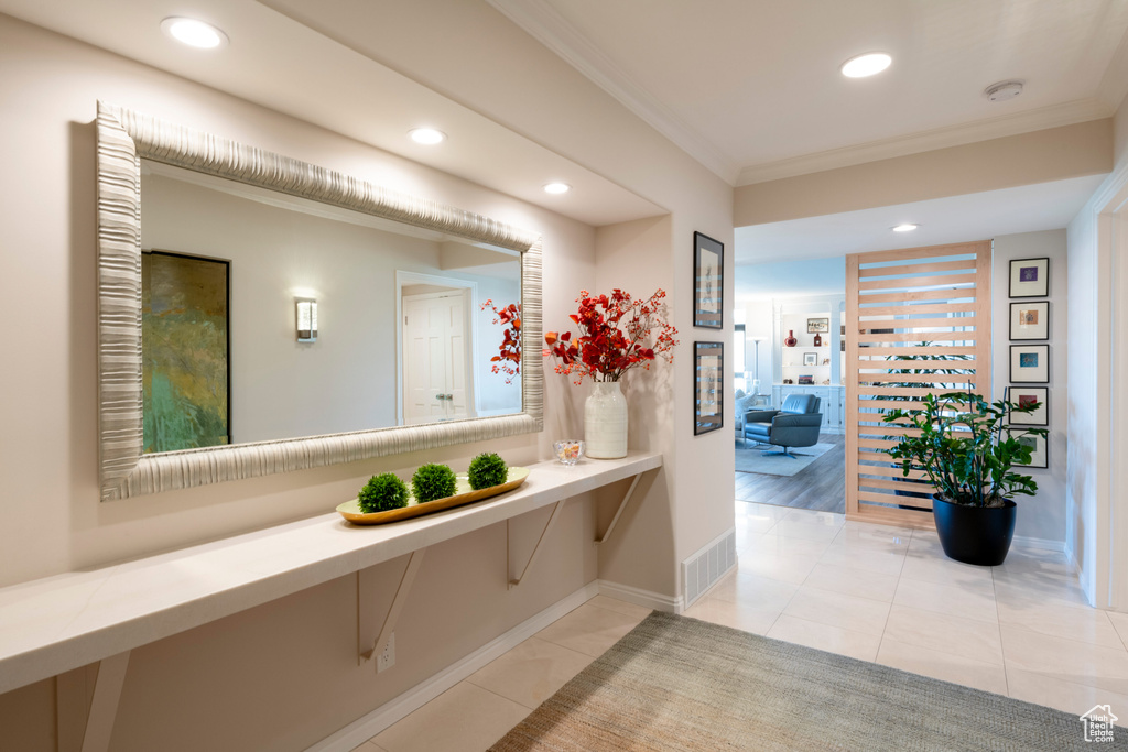 Interior space featuring light wood-type flooring and crown molding