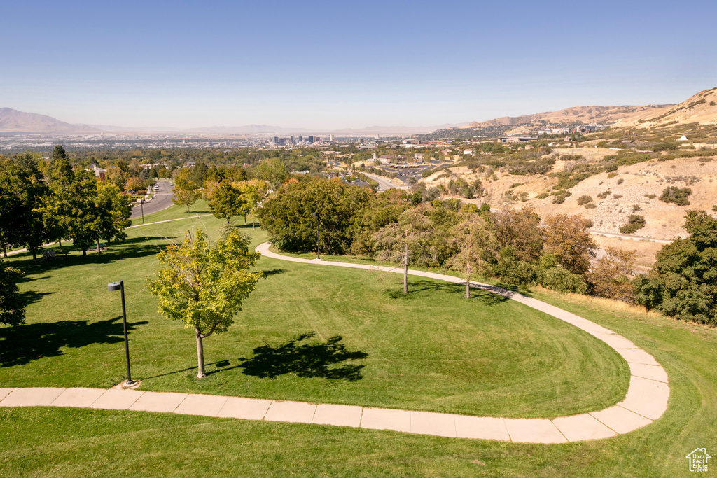 View of community with a mountain view and a lawn