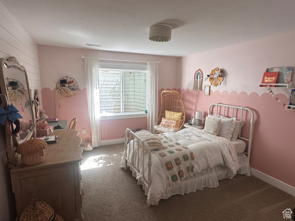 Carpeted bedroom featuring a textured ceiling