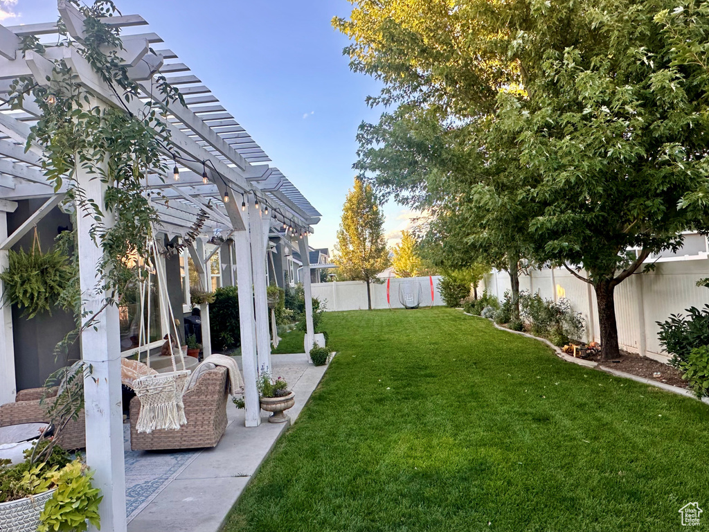 View of yard with a pergola and a patio