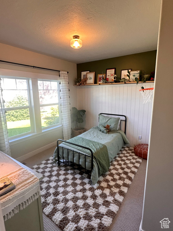 Carpeted bedroom featuring a textured ceiling