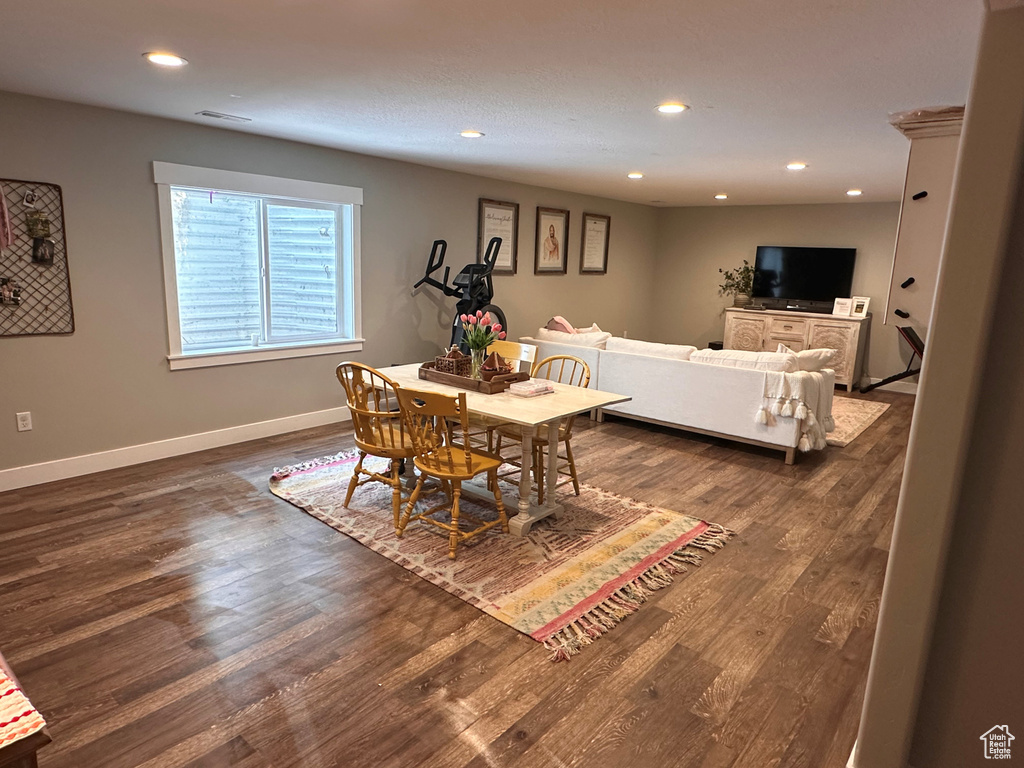 Dining area with dark hardwood / wood-style flooring