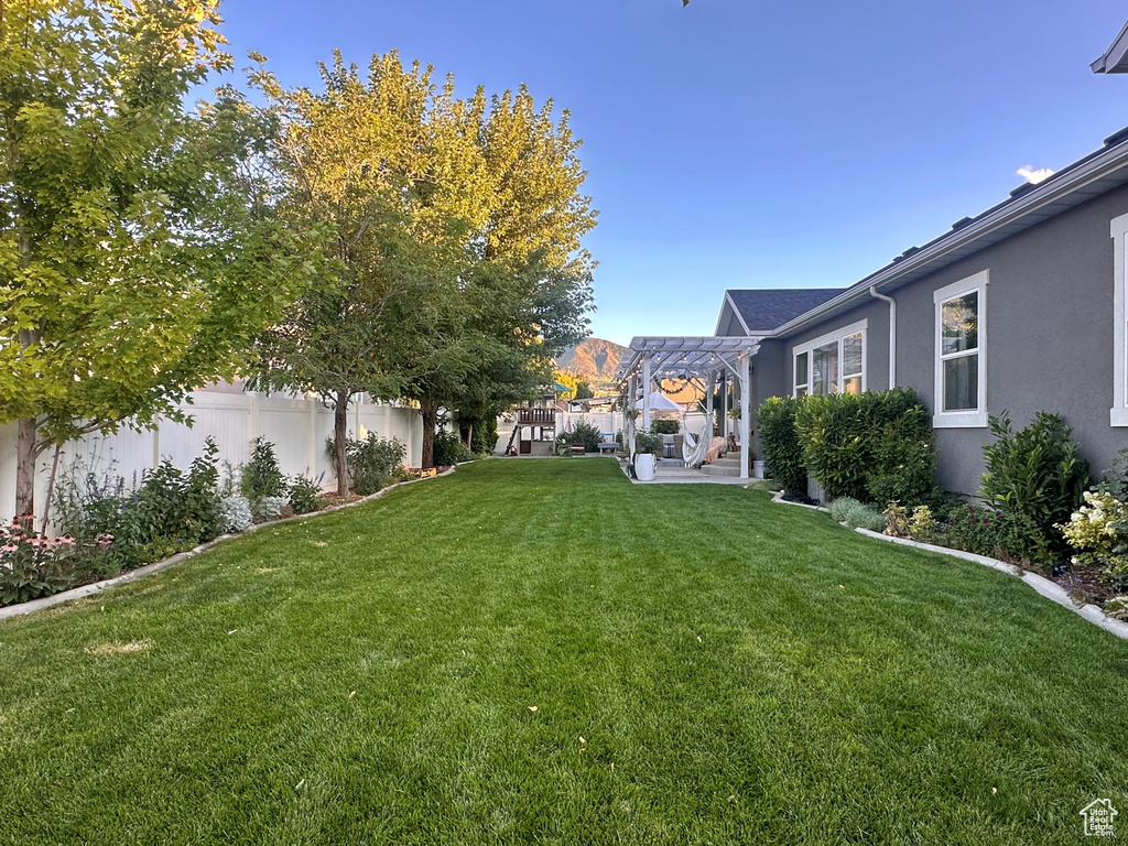 View of yard with a pergola and a patio area