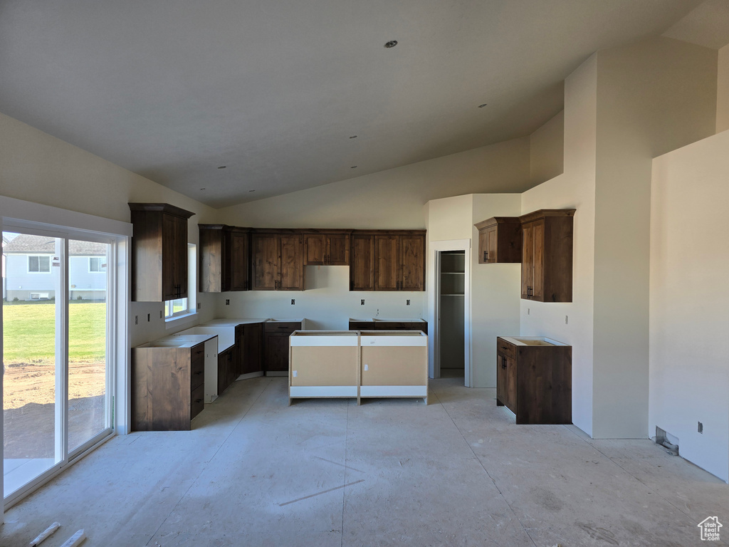 Kitchen with dark brown cabinets and vaulted ceiling