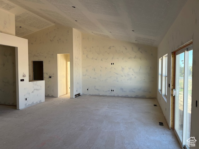 Empty room featuring lofted ceiling