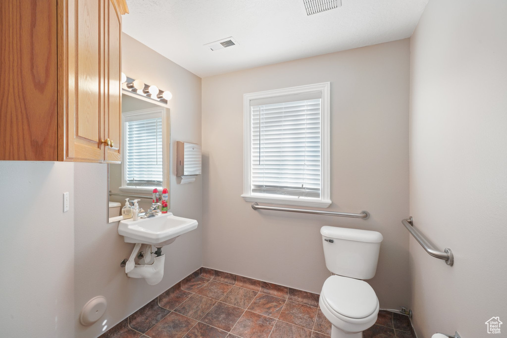 Bathroom featuring sink and toilet