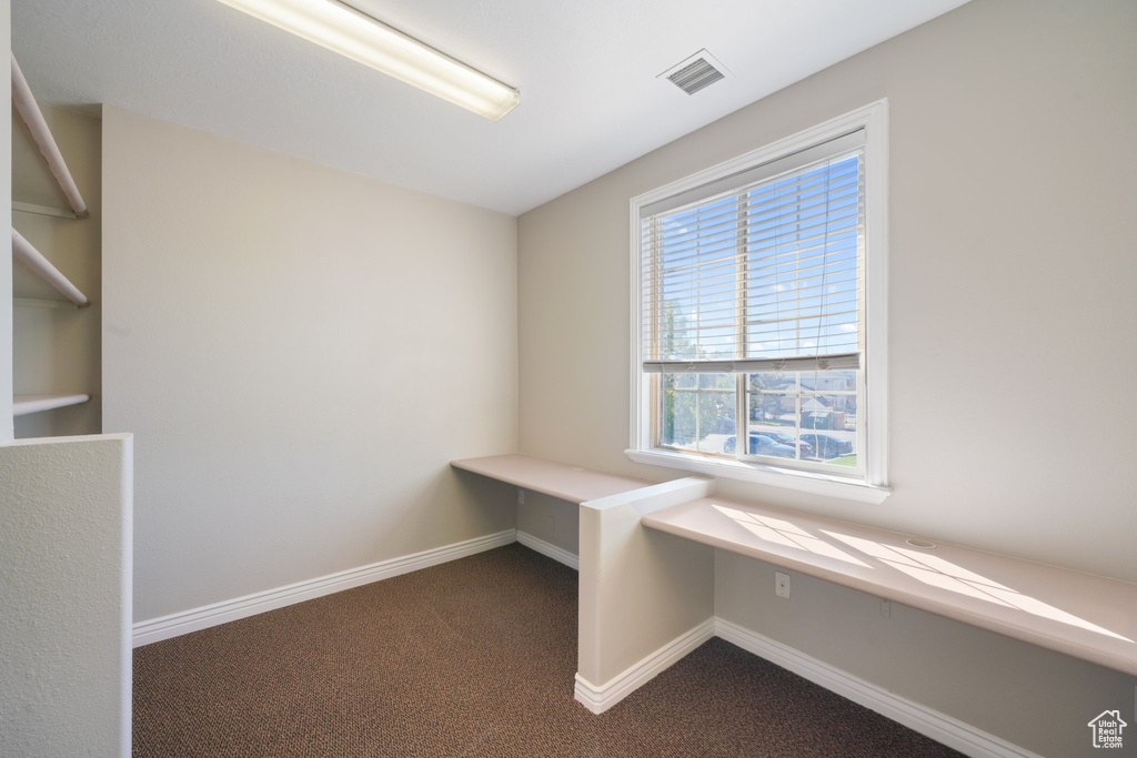 Interior space featuring dark colored carpet