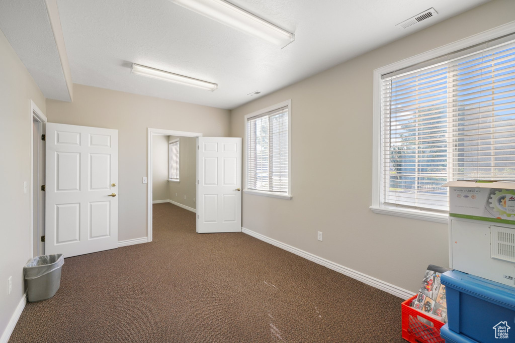 Playroom featuring dark carpet and a healthy amount of sunlight