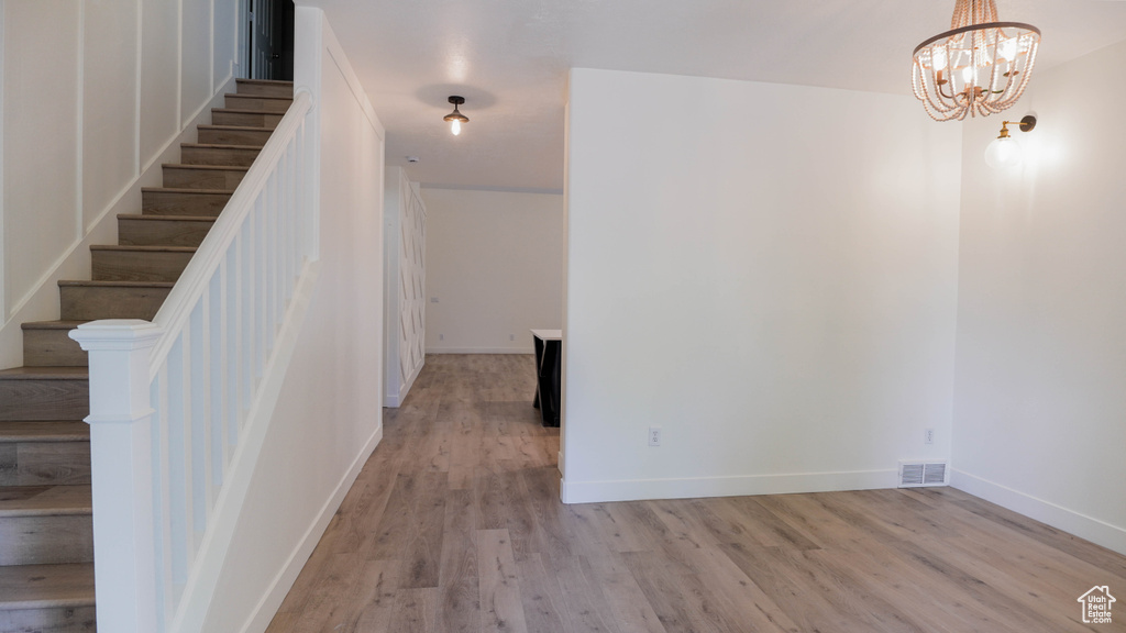 Interior space with a chandelier and hardwood / wood-style flooring