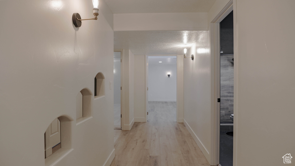 Hall featuring light wood-type flooring