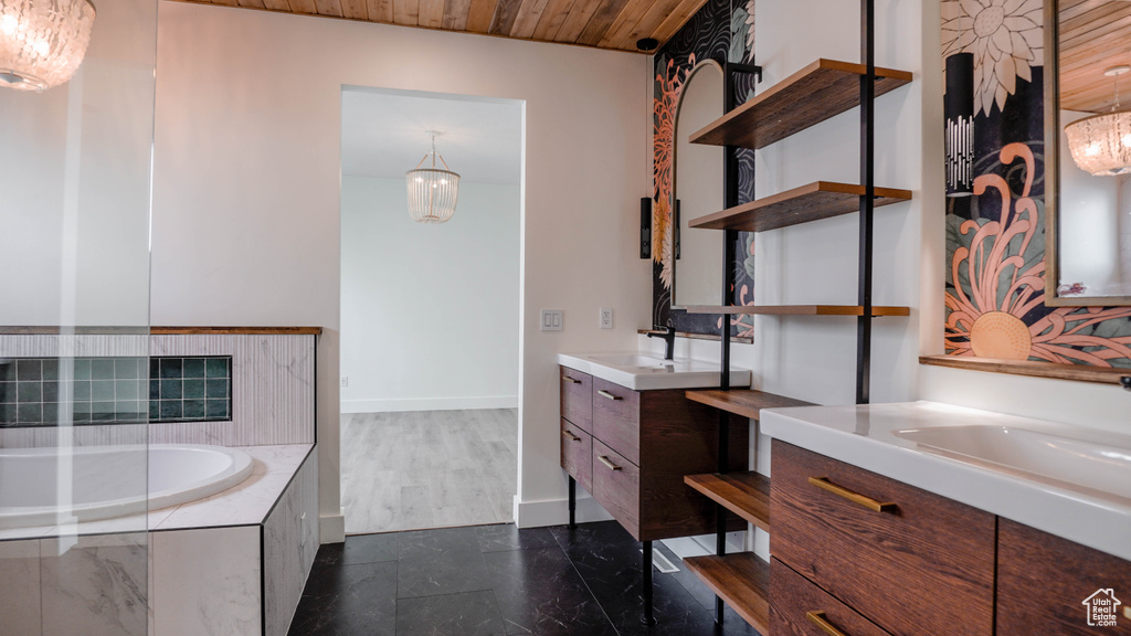 Bathroom featuring vanity, a relaxing tiled tub, wood ceiling, and wood-type flooring