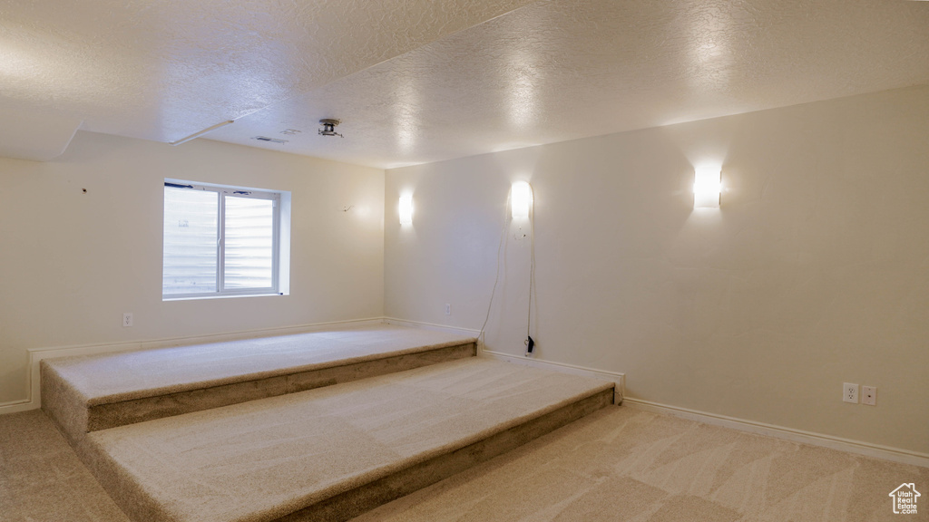 Unfurnished bedroom featuring a textured ceiling and carpet