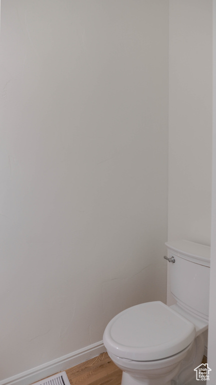 Bathroom with wood-type flooring and toilet