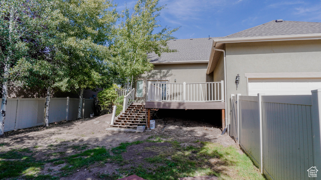 View of yard featuring a deck and a garage