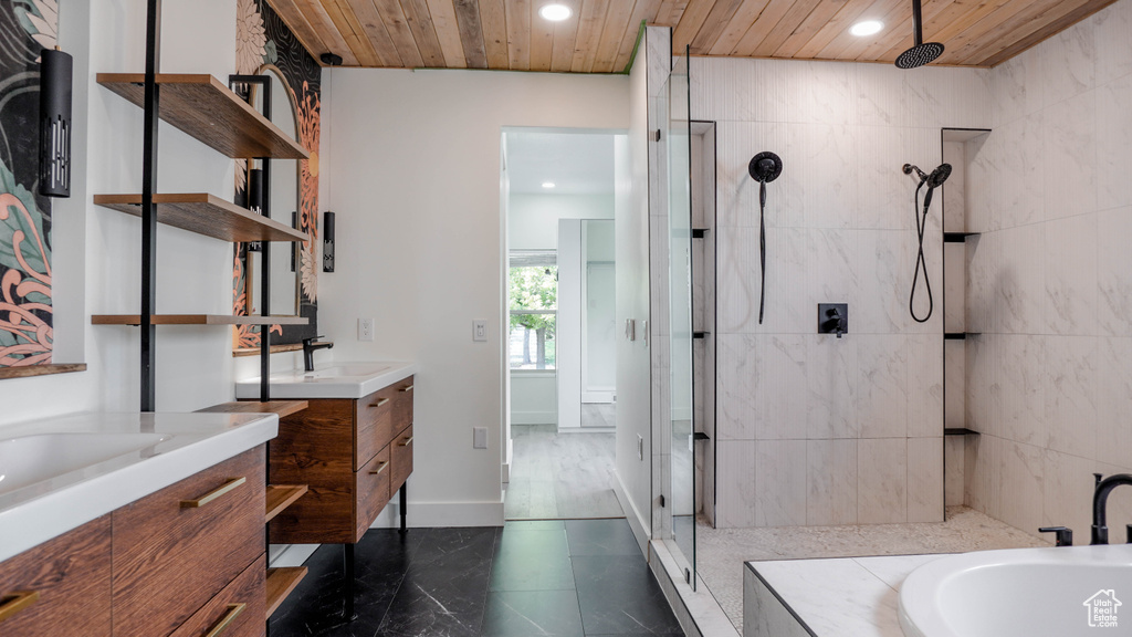 Bathroom with wooden ceiling, vanity, and separate shower and tub