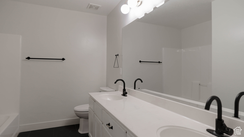 Full bathroom featuring independent shower and bath, vanity, tile patterned flooring, and toilet