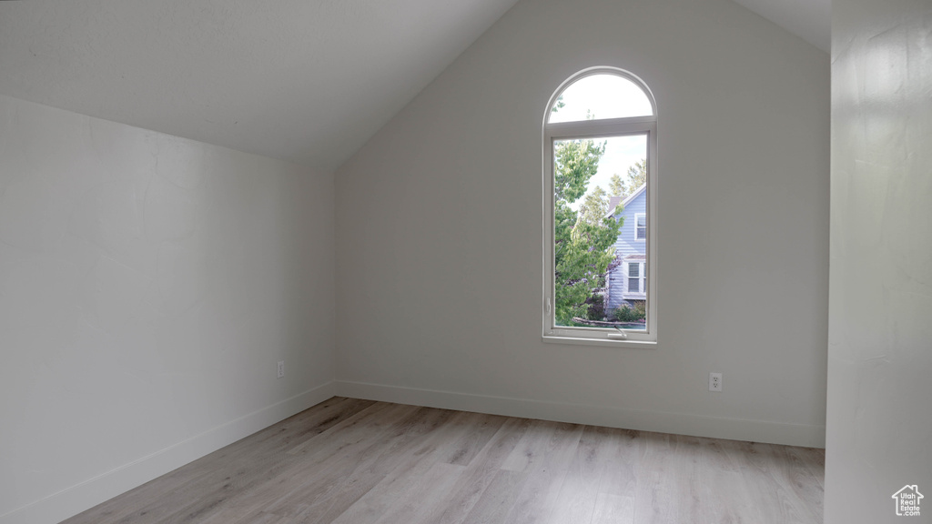 Additional living space featuring lofted ceiling and light hardwood / wood-style floors